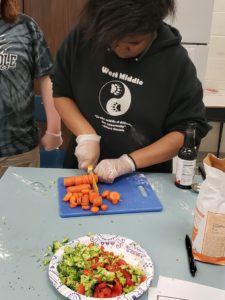 teen cutting vegetables