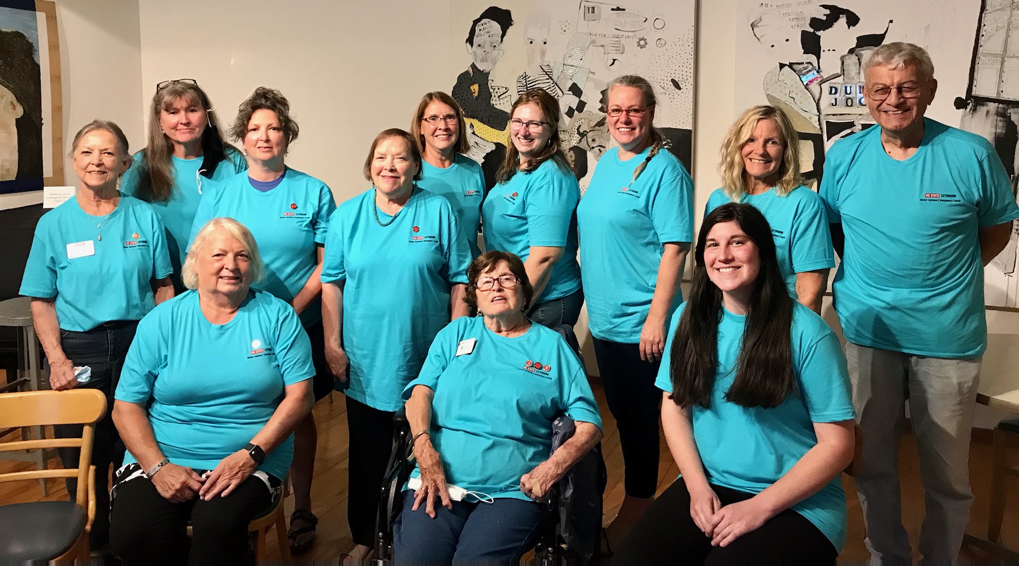 A group of Master Gardener℠ volunteers wearing blue shirts.